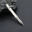 Bright silver titanium bolt action pen with the writing tip extended beside dark stone