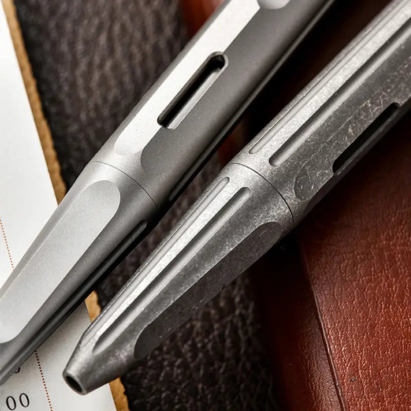 Close-up of titanium EDC pen and pry bar