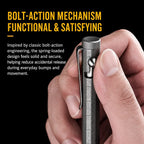 Thumb on the side bolt of a stonewashed titanium pen, showing the bolt track and pocket clip